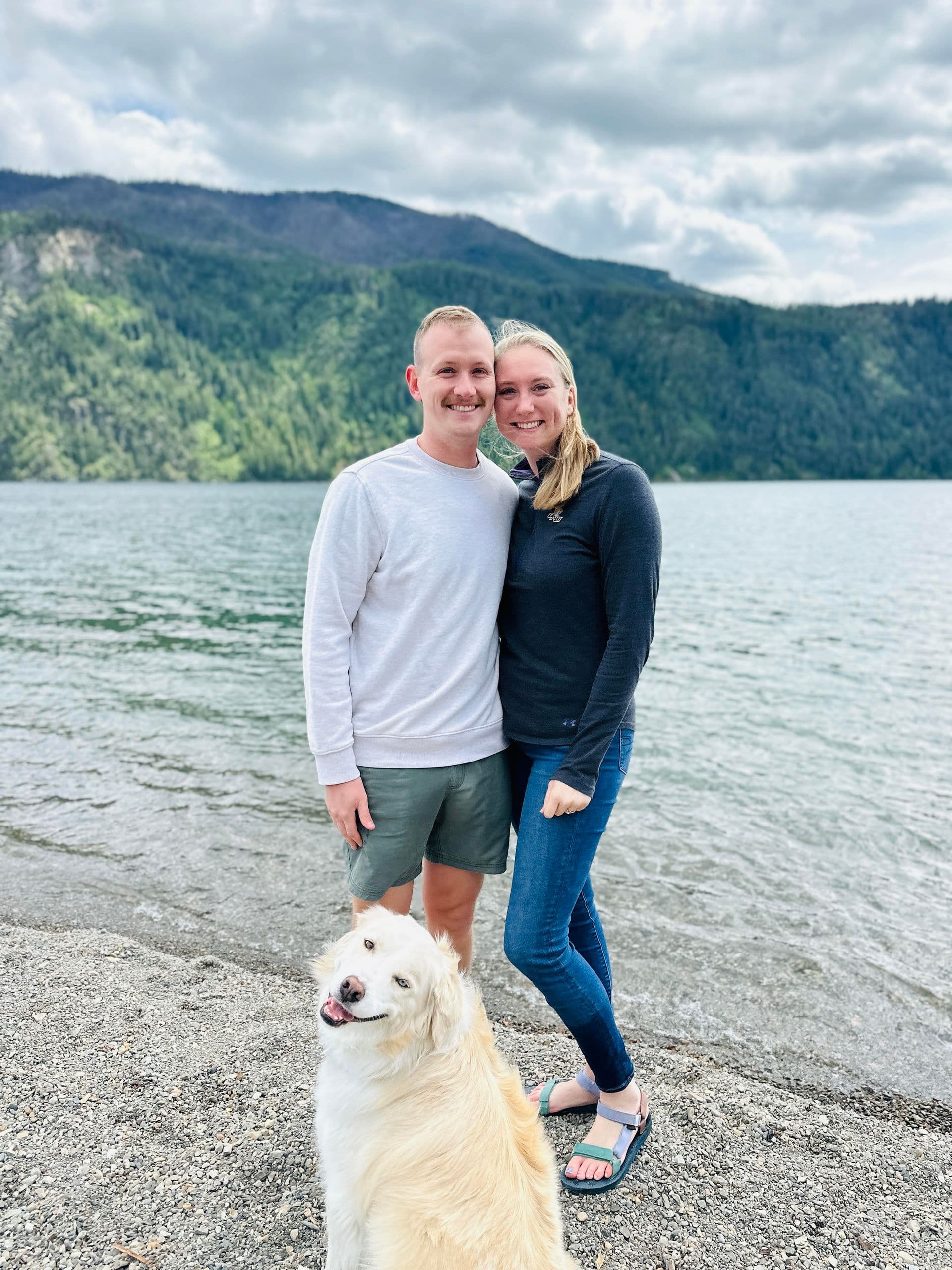 Mason and Ashley Garner, owners of Maha Coffee Roasters, with their dog by the lake in Coeur d'Alene, Idaho